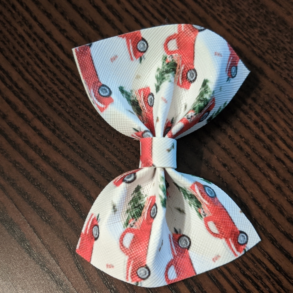 Faux leather bow with red trucks and trees, NWOT